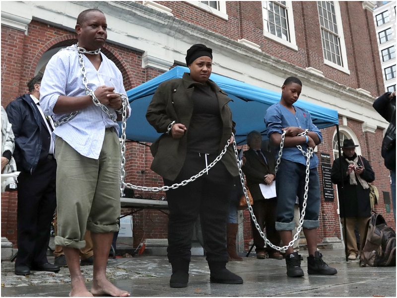 Protestors reenact slave auction